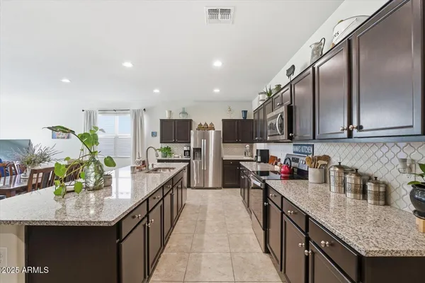 a kitchen with stainless steel appliances granite countertop sink microwave and stove