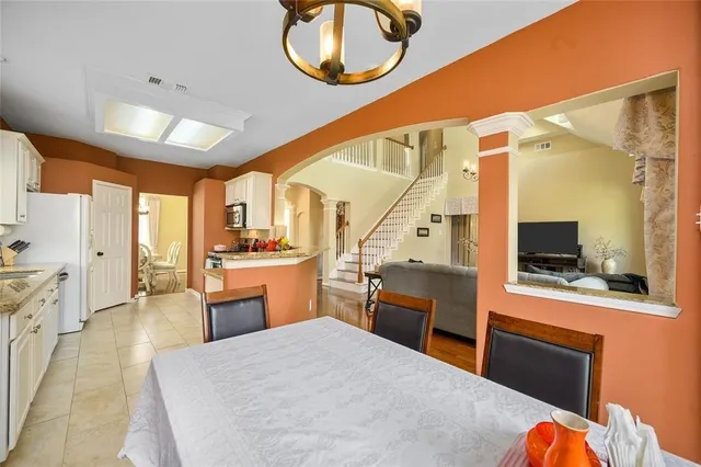 a large white room with a large window and stainless steel appliances