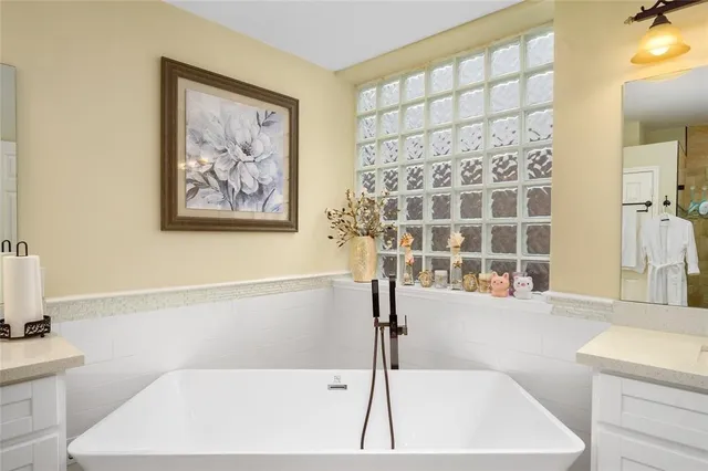 a bathroom with a bathtub and a shower