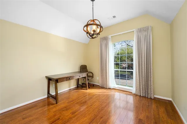 a view of a room with wooden floor fan and window