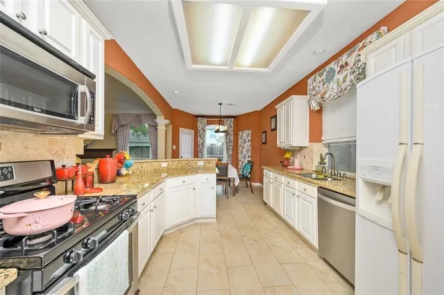 a kitchen with stainless steel appliances granite countertop a stove and a sink