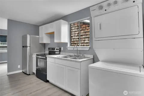 a kitchen with a stove and a refrigerator