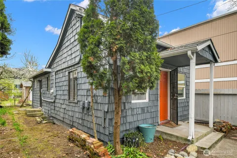 a view of a house with wooden fence