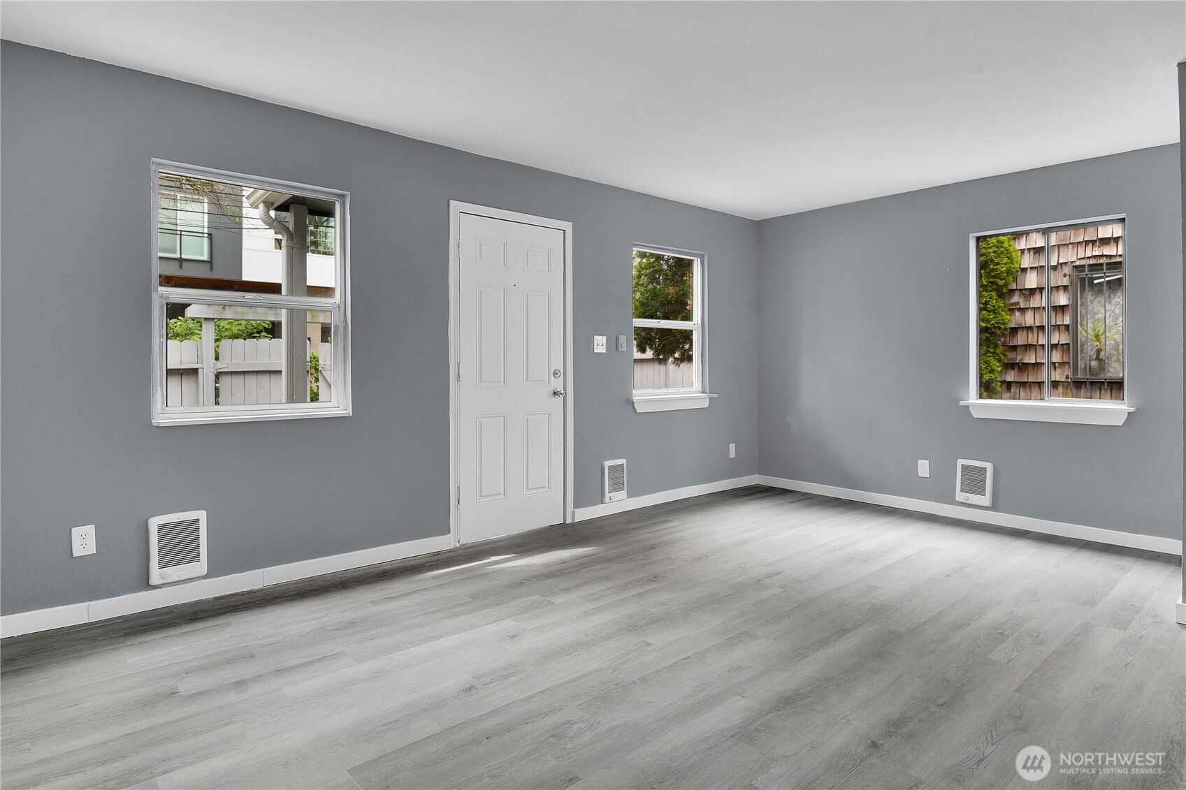 324 26th Avenue South Seattle, WA 98144 - Photo 3 of 7 a view of an empty room with window and wooden floor
