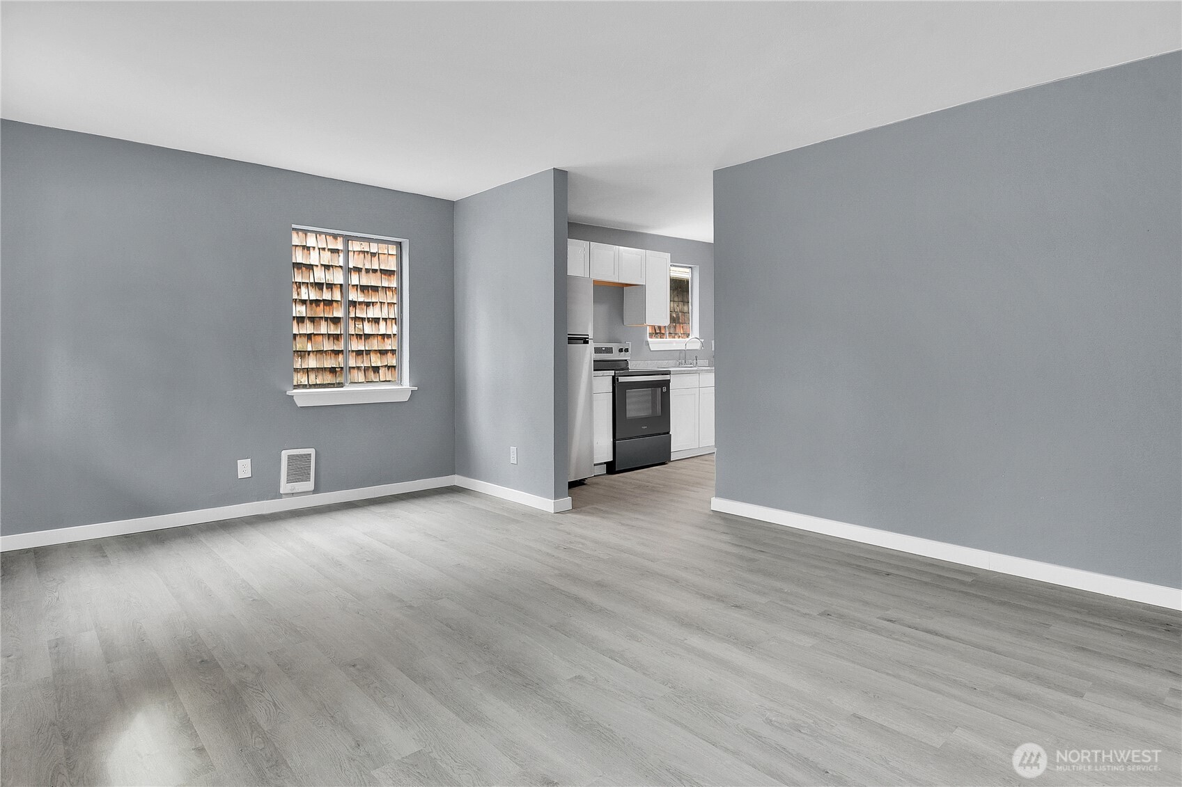 324 26th Avenue South Seattle, WA 98144 - Photo 4 of 7 a view of an empty room with a window and wooden floor
