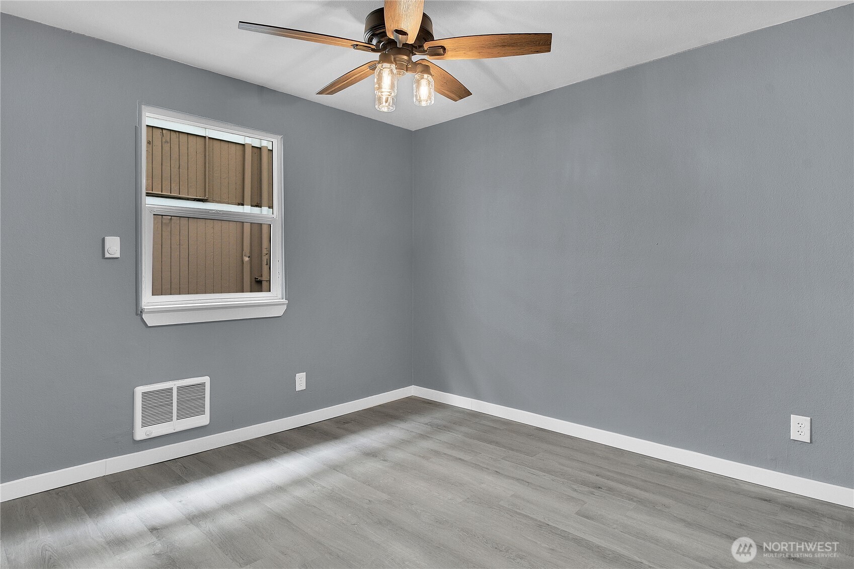 324 26th Avenue South Seattle, WA 98144 - Photo 5 of 7 a view of an empty room with window and wooden floor