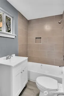 a bathroom with a sink a toilet and bathtub