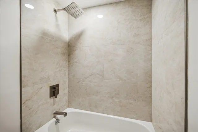 a bathroom with a shower and a bath tub
