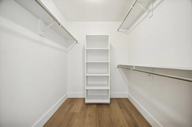 a view of walk in closet with empty racks