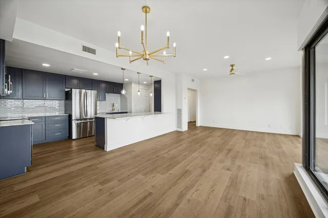a view of kitchen with sink and refrigerator