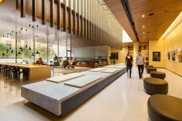 a living room with large pool table and chairs