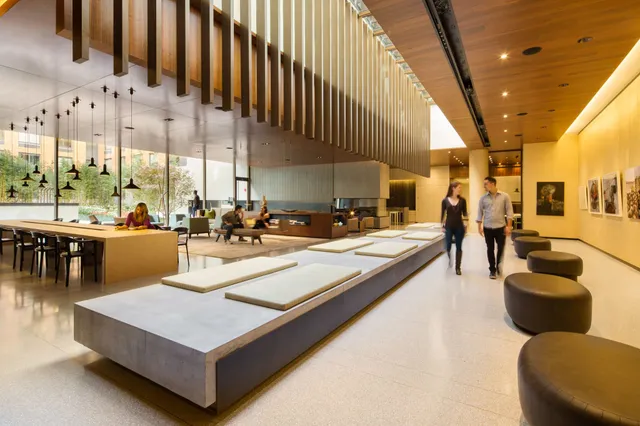 a living room with large pool table and chairs
