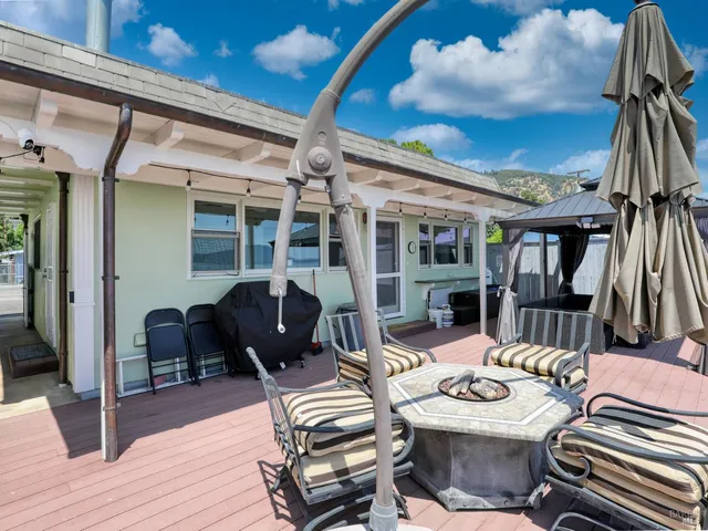 a view of a patio with table and chairs