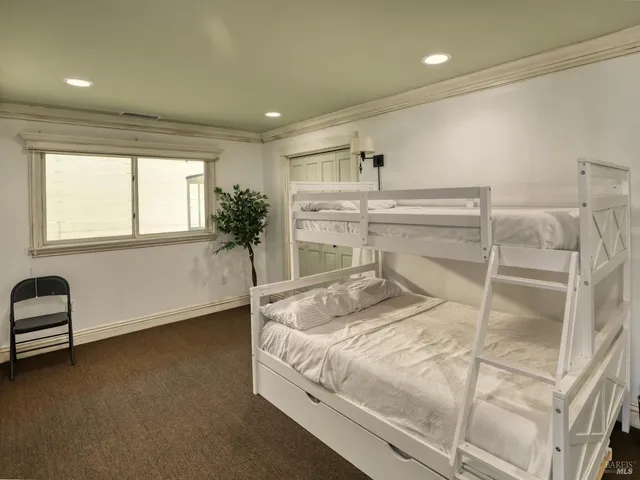 a bedroom with a bed and ceiling fan
