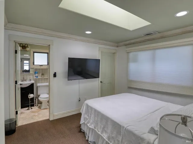 a kitchen with a sink and chairs
