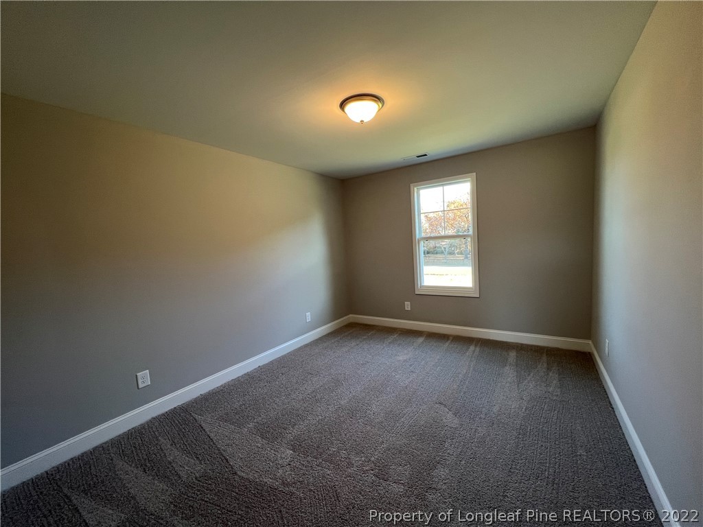 7830 Rufus Johnson Road Fayetteville, NC 28306 - Photo 12 of 20 an empty room with a window