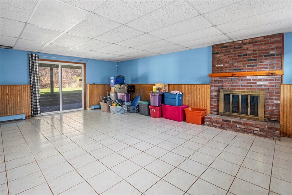 17 Maplewood Road Pembroke, MA 02359 - Photo 18 of 26 a view of an empty room with projector and kitchen view