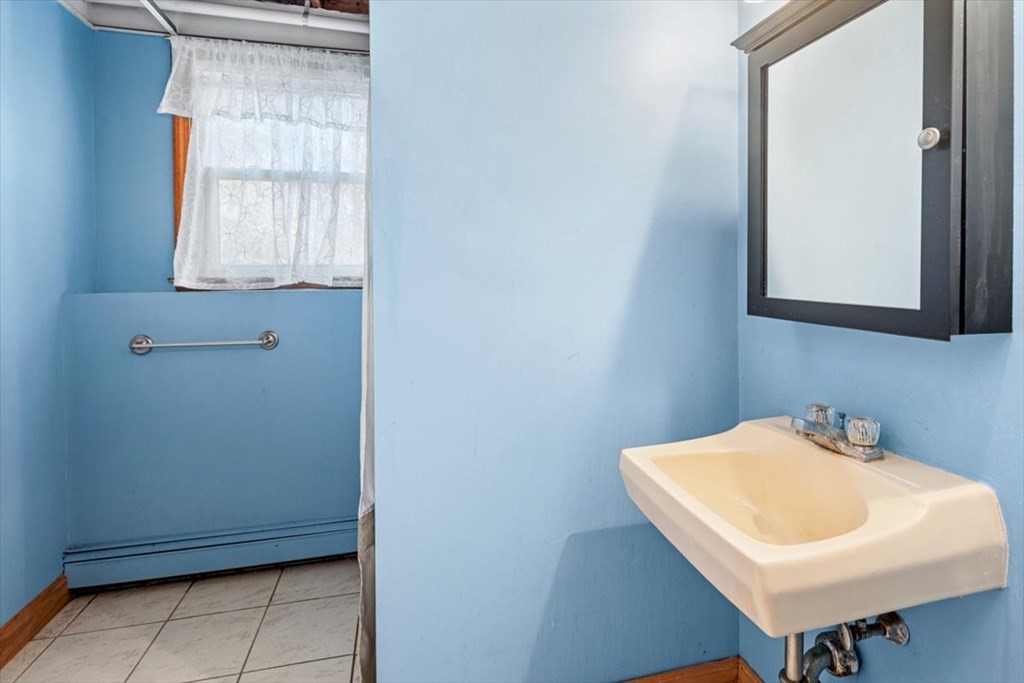 17 Maplewood Road Pembroke, MA 02359 - Photo 20 of 26 a bathroom with a sink a window and a toilet