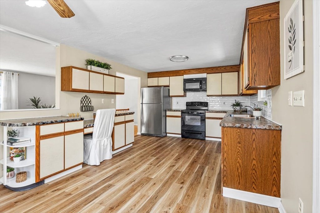 17 Maplewood Road Pembroke, MA 02359 - Photo 9 of 26 a kitchen with stainless steel appliances granite countertop a stove top oven a sink and dishwasher