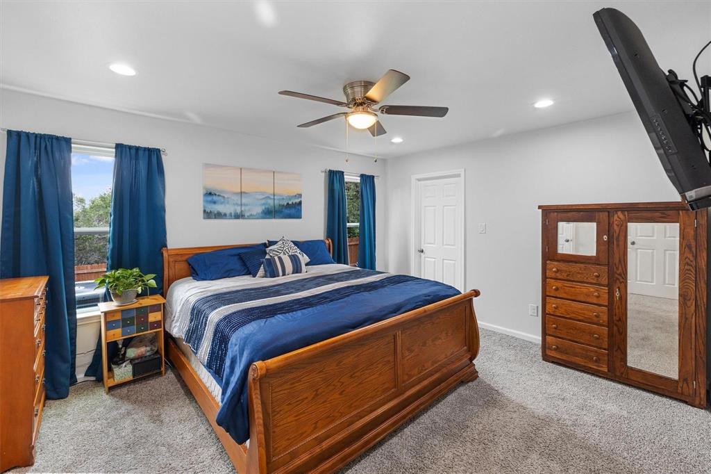 4720 Evening View Drive Granbury, TX 76048 - Photo 11 of 25 a bed room with a bed and a ceiling fan