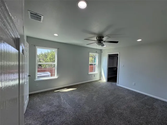 an empty room with windows and closet