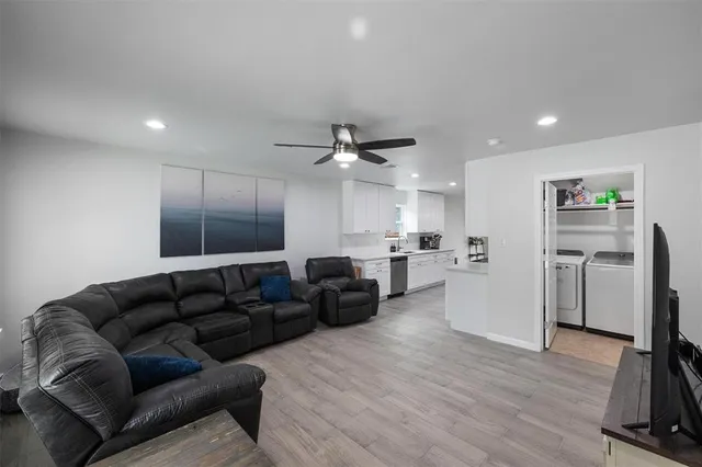 a living room with furniture window and wooden floor