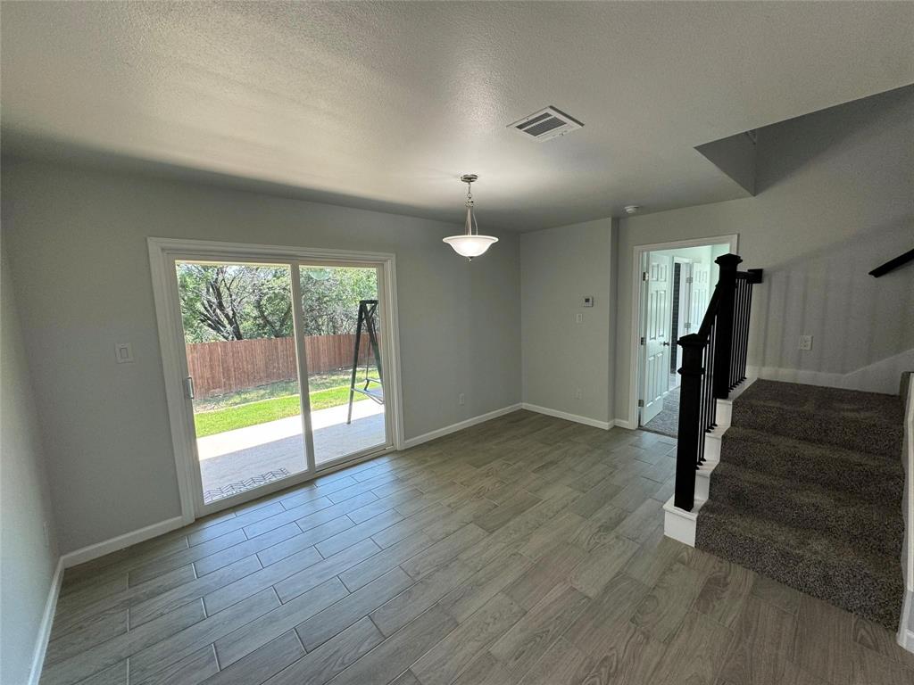 4720 Evening View Drive Granbury, TX 76048 - Photo 8 of 25 a view of empty room with wooden floor and fan
