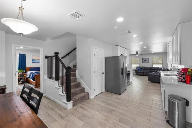 a view of a room with wooden floor and stairs