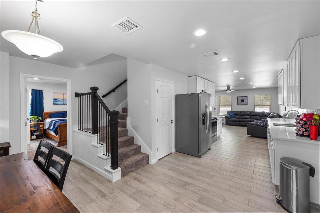4720 Evening View Drive Granbury, TX 76048 - Photo 9 of 25 a view of a room with wooden floor and stairs