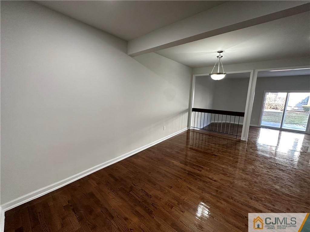 3703 Hana Road Edison, NJ 08817 - Photo 7 of 55 an empty room with wooden floor and windows