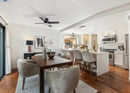 a dining room with furniture and wooden floor