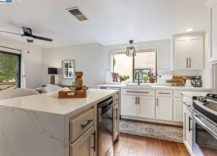 a kitchen with a sink stove and cabinets