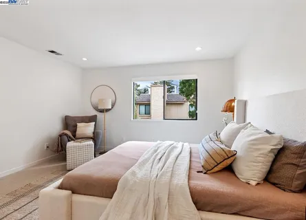 a bedroom with a bed and window
