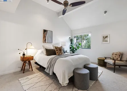 a bedroom with bed and a window