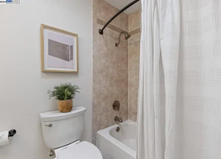 a bathroom with a toilet a sink and bathtub