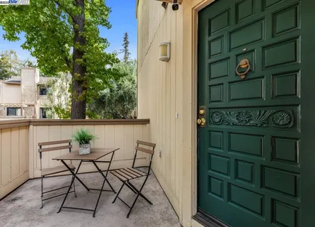 a view of a chairs and table in a balcony
