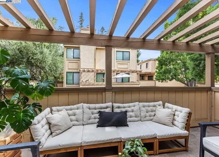 a balcony with furniture and wooden floor