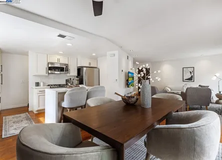 a living room with furniture and a view of kitchen