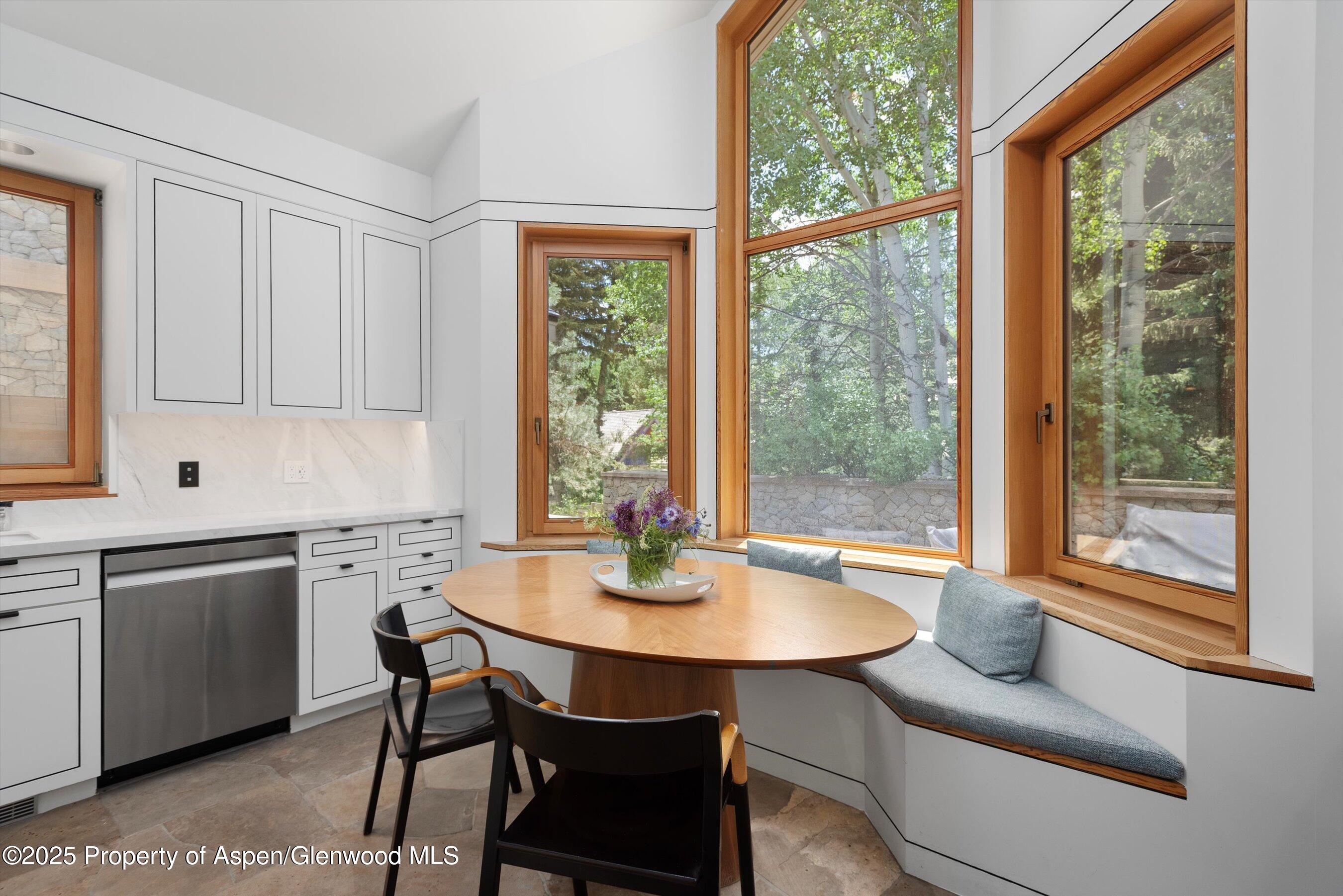 800 Roaring Fork Road Aspen, CO 81611 - Photo 11 of 37 a kitchen with a table chairs and wooden floor
