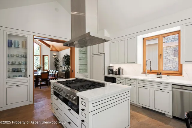 a kitchen with a stove a sink and a refrigerator