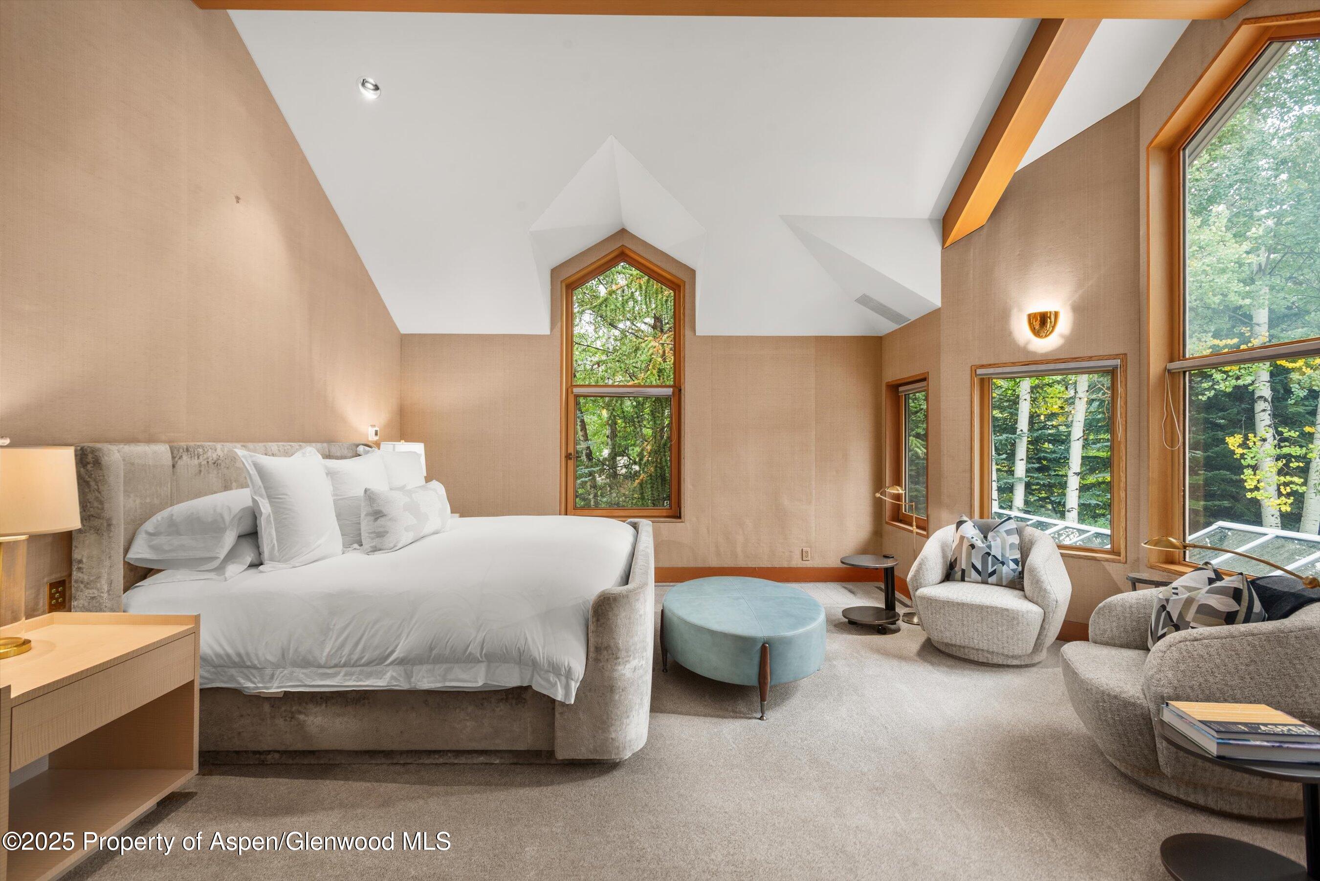 800 Roaring Fork Road Aspen, CO 81611 - Photo 13 of 37 a spacious bedroom with a bed and large windows