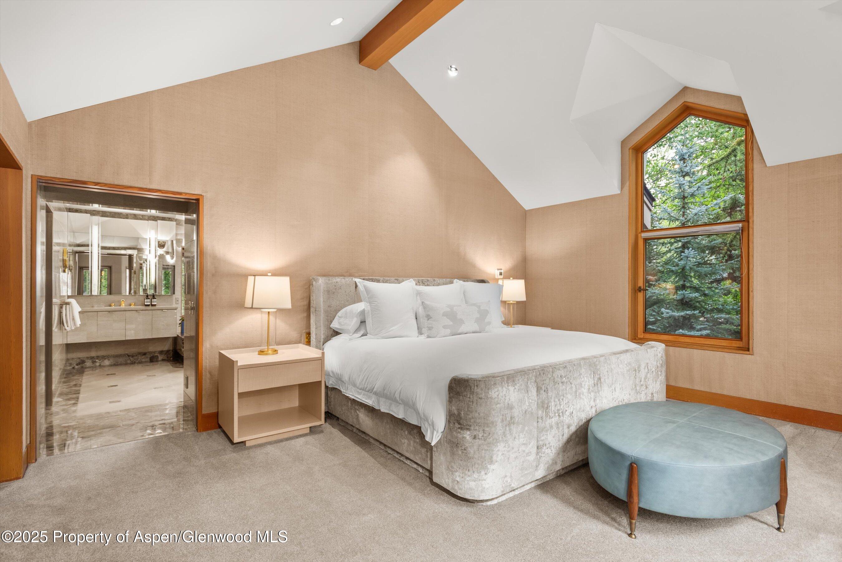 800 Roaring Fork Road Aspen, CO 81611 - Photo 15 of 37 a spacious bedroom with a bed and a large window