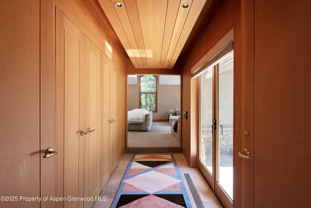 a bedroom with furniture and large windows