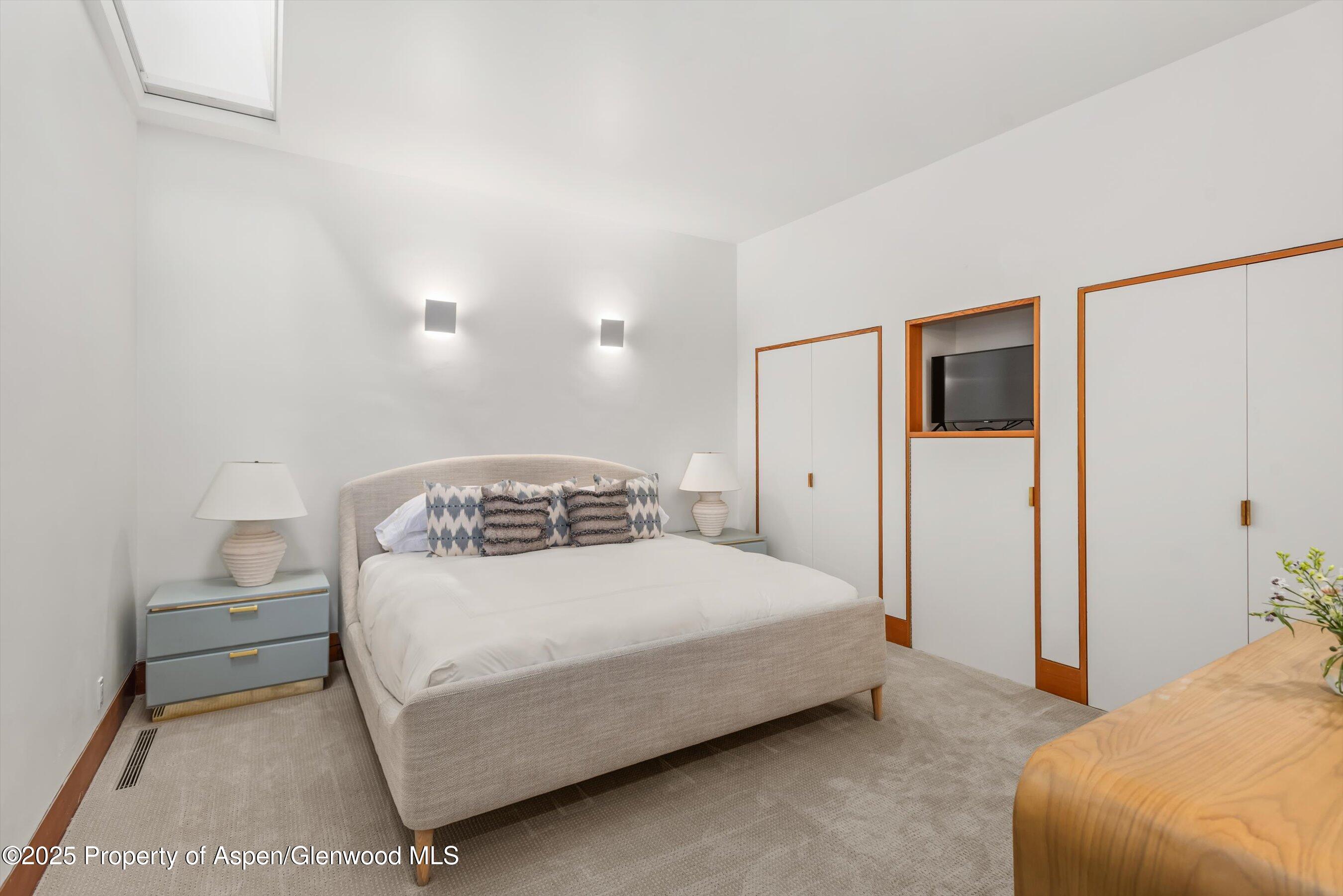 800 Roaring Fork Road Aspen, CO 81611 - Photo 25 of 37 a bedroom with a bed and a refrigerator