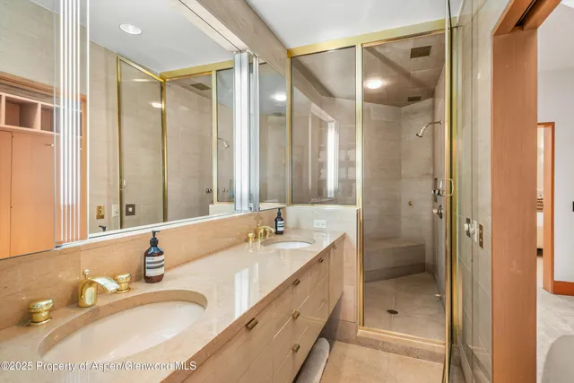 a bathroom with a tub sink shower and mirror