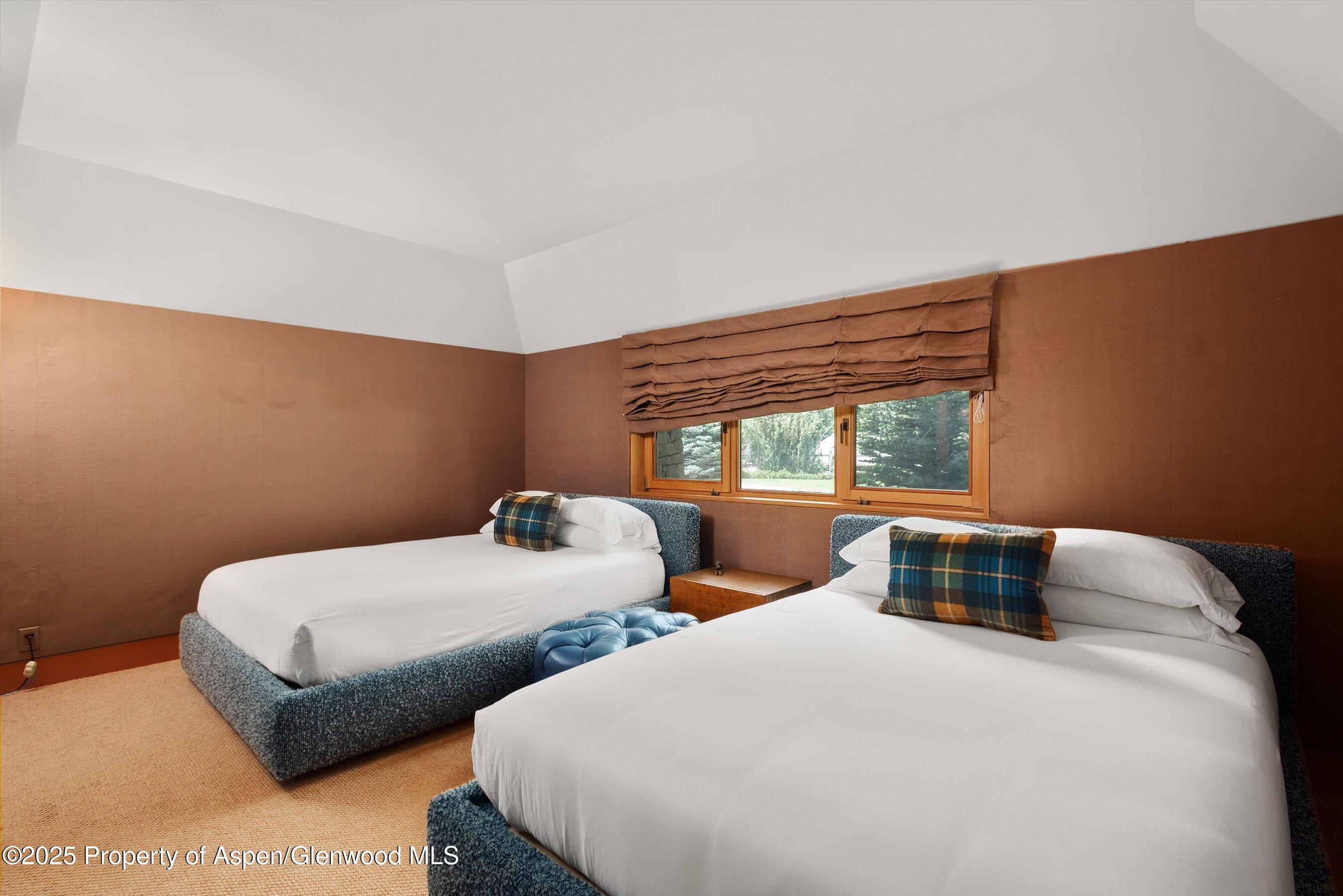 800 Roaring Fork Road Aspen, CO 81611 - Photo 27 of 37 a bedroom with two beds and a large window
