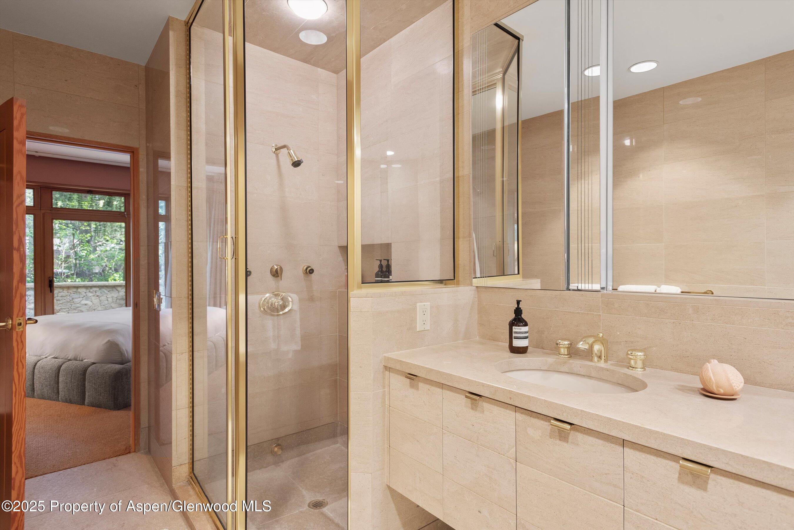 800 Roaring Fork Road Aspen, CO 81611 - Photo 31 of 37 a bathroom with a granite countertop sink and a mirror