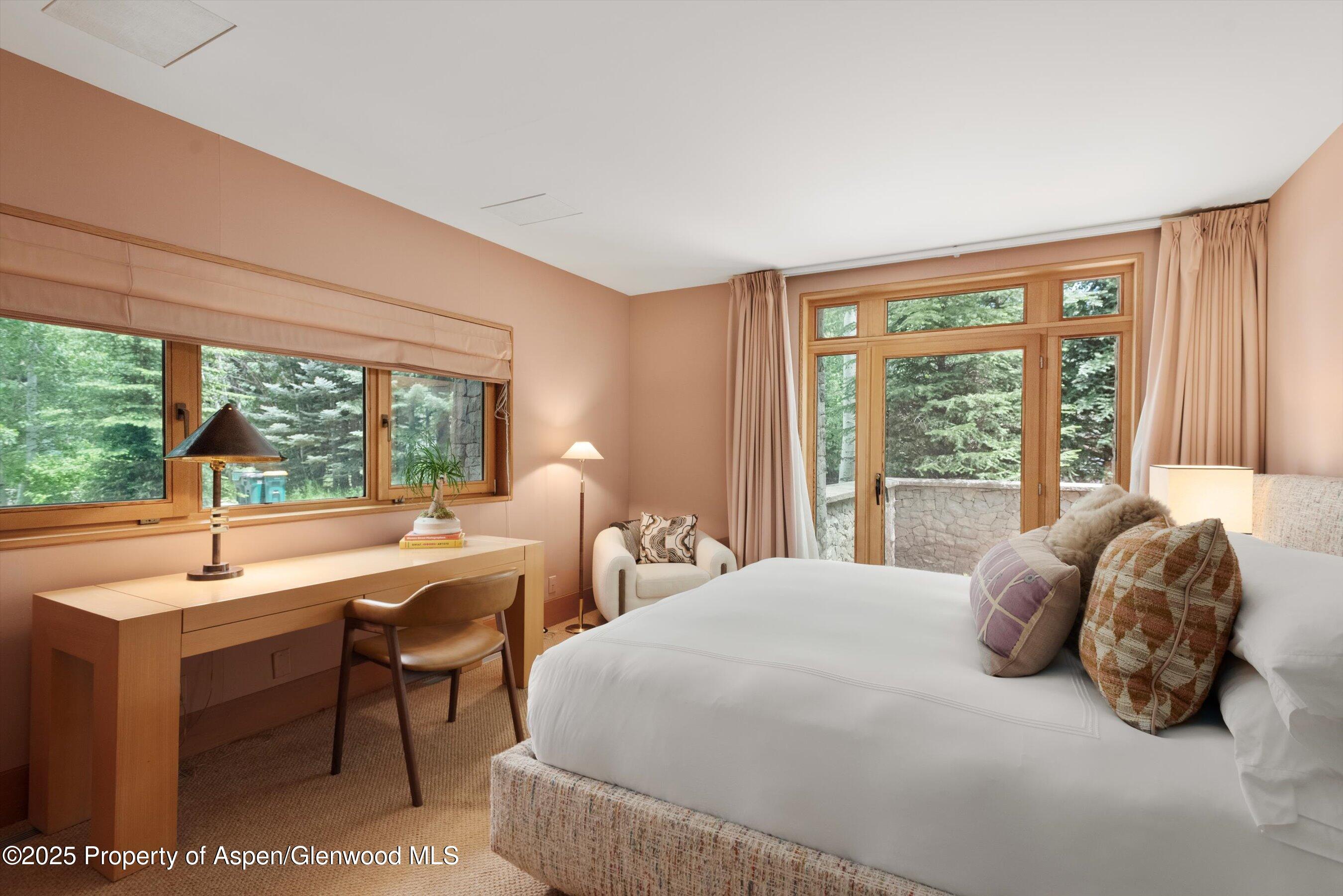 800 Roaring Fork Road Aspen, CO 81611 - Photo 32 of 37 a bedroom with a bed and a large window