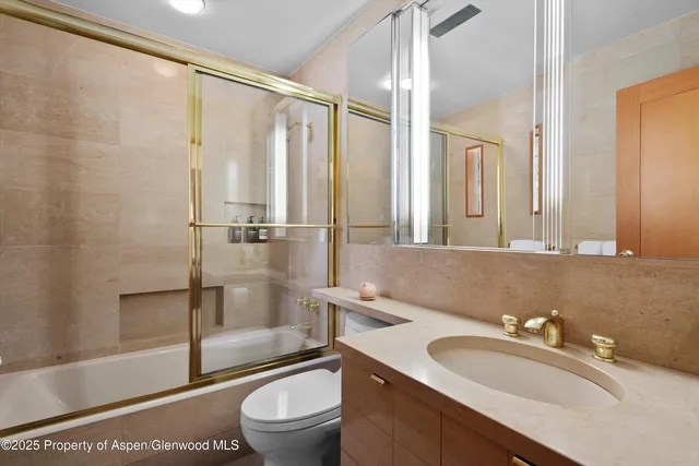 a bathroom with a sink a toilet and a shower