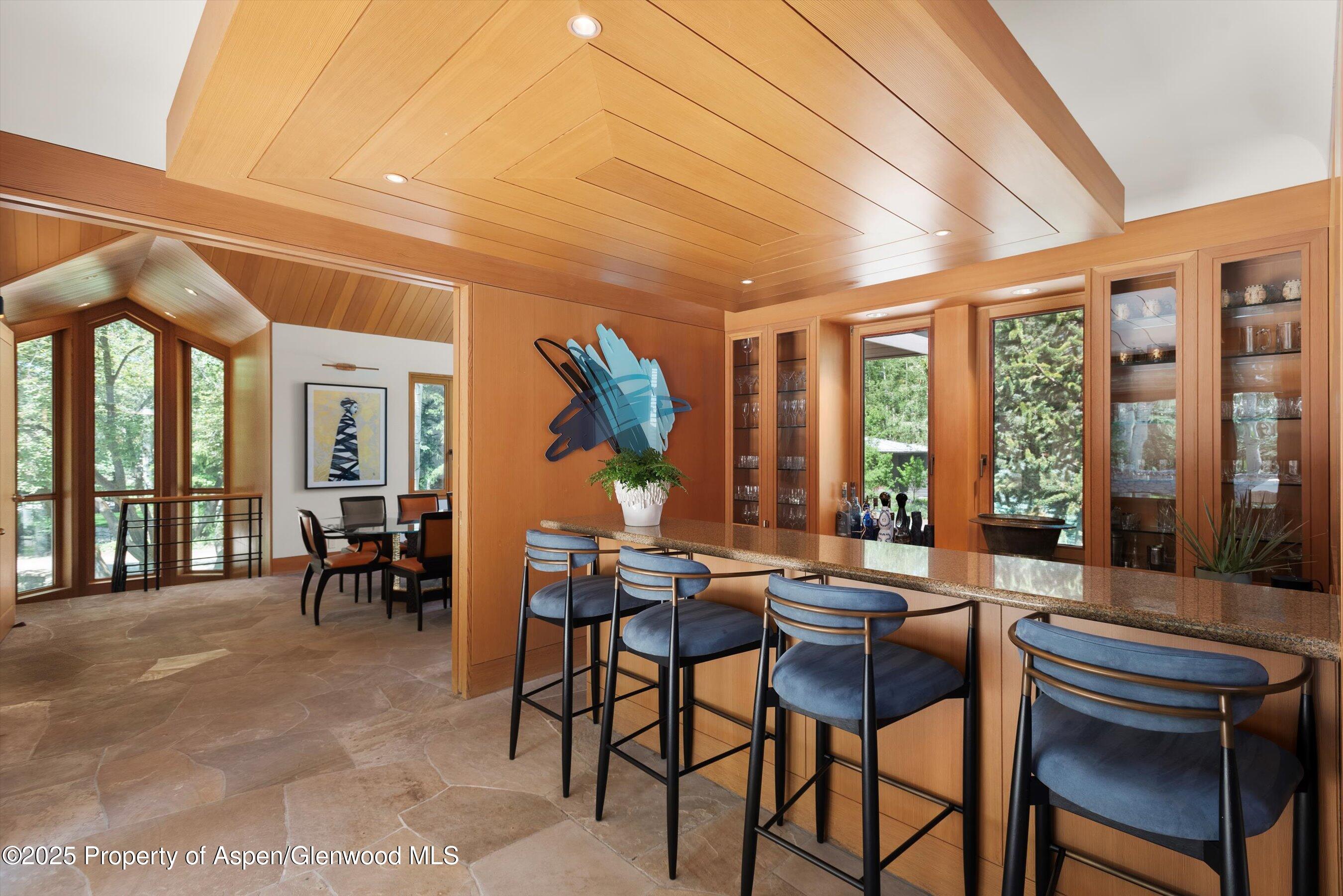 800 Roaring Fork Road Aspen, CO 81611 - Photo 8 of 37 a dining room with furniture and large windows